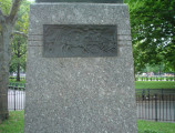 Figure (heroic scale) on integral plinth, pedestal with four recessed relief plaques