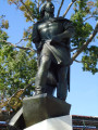 Standing figure (over life size) on pedestal, on plinth