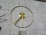 Abstract kinetic sculpture in the form of a clock whose arms form the peace sign twice a day (at 4pm and 4am).