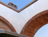 white and grey trompe l'oeil mural on archway entry of McCarren Park Pool Play Center