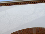 white and grey trompe l'oeil mural on archway entry of McCarren Park Pool Play Center