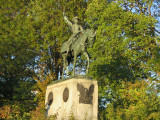 Equestrian figure on pedestal embellished with relief eagle on front, four medallions (two on each side)