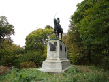 Equestrian figure on pedestal embellished with relief eagle on front, four medallions (two on each side)