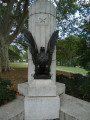 Doric column surmounted by a bronze urn, on a terrace approached by 100 steps; eagles at corners of terrace; plaque and tablet