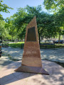 Bust (life size) recessed in pyramidal monument, two plaques with reliefs