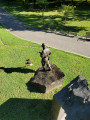 Over lifesized figure of soldier on mound, with separate mountainscape and honor-roll behind