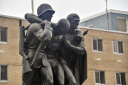 Group of three figures (heroic scale), integral plinth, on pedestal