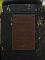 Plaque mounted on flagpole plinth