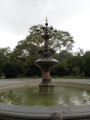 fountain with bronze and wrought iron finial on top a polychrome masonry base