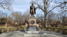 Standing figure (over life-size) on integral plinth on pedestal with wreaths and insignia of US Army and Navy at front and rear, and two eagles, one proper left and one proper right