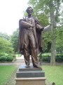 Standing figure (over life-size) on integral plinth on pedestal with wreaths and insignia of US Army and Navy at front and rear, and two eagles, one proper left and one proper right