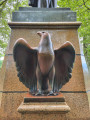 Standing figure (over life-size) on integral plinth on pedestal with wreaths and insignia of US Army and Navy at front and rear, and two eagles, one proper left and one proper right