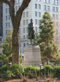 Standing figure (over life-size) with integral plinth on pedestal