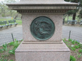 Portrait statue on pedestal with medallions