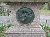 Portrait statue on pedestal with medallions