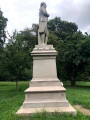 Standing figure (over life-size) on intergral plinth, on pedestal