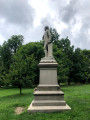 Standing figure (over life-size) on intergral plinth, on pedestal