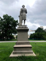 Standing figure (over life-size) on intergral plinth, on pedestal