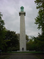 Doric column surmounted by a bronze urn, on a terrace approached by 100 steps; eagles at corners of terrace; plaque and tablet