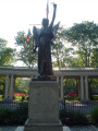 Standing female figue with integral plinth on pedestal