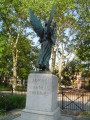 Standing female figue with integral plinth on pedestal