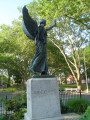 Standing female figue with integral plinth on pedestal