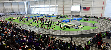 an indoor track with stadium seating