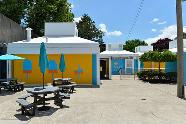 Fisher pool’s picnic area is enhanced by blue umbrellas and vibrant decals and paint on the walls.