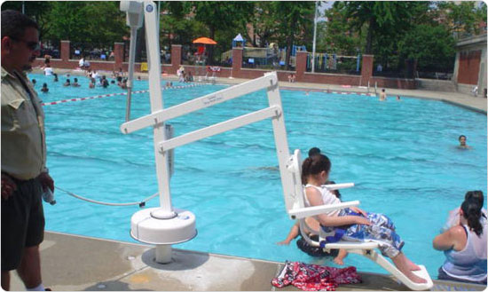 A child gets lowered into the Hamilton Fish outdoor pool on June 28, 2008