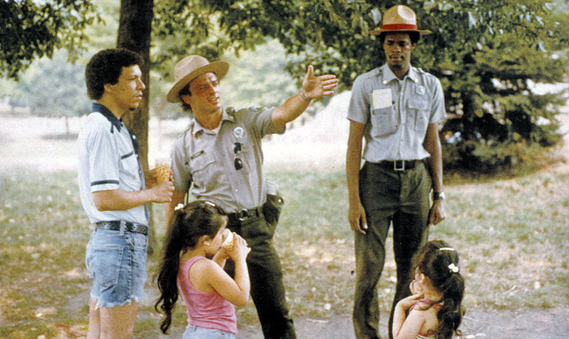 Urban Park Ranger and future NYC Parks Commissioner Adrian Benepe helps a park goer find their way.