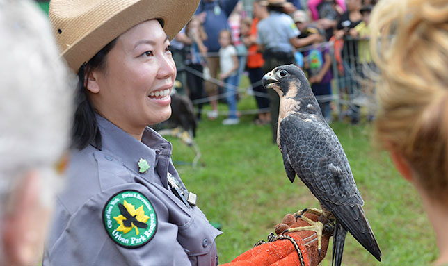 Urban Park Ranger holding an eagle