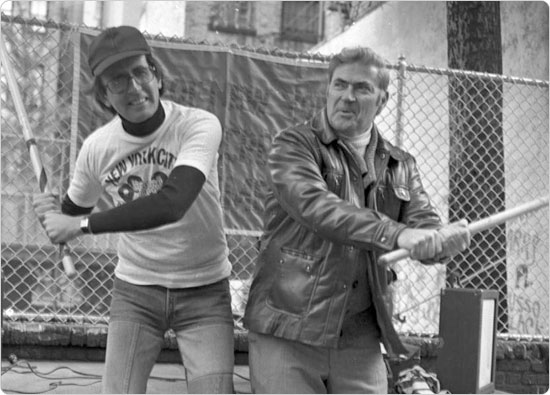 Image of Men take a break from a Parks-sponsored stickball tournament on Thompson Street in Manhattan to pose for the camera. October 1977. Neg. 53027.11