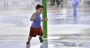 A child running through a spray shower.