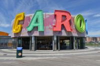 The letters "C-A-R-O" are prominent on the whimsical B&B Carousell building on a sunny day..