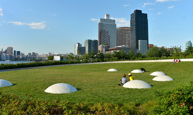 White mounds on an open lawn area depicts craters, valleys, and mountains on the moon.