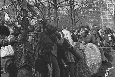 Youthful zeal and environmental activism join forces as celebrants hoist a tree at Union Square Park on the first Earth Day