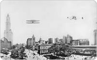 Panorama with Biplane Overhead and Old Post Office, 1913, Irving Underhill