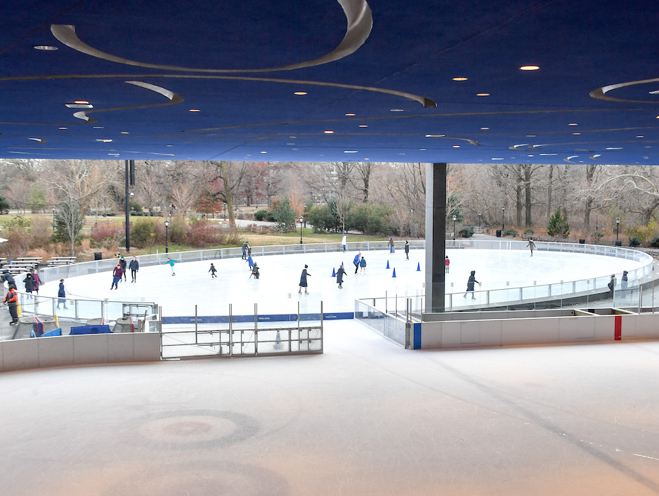 ice skaters enjoy the rink in the park