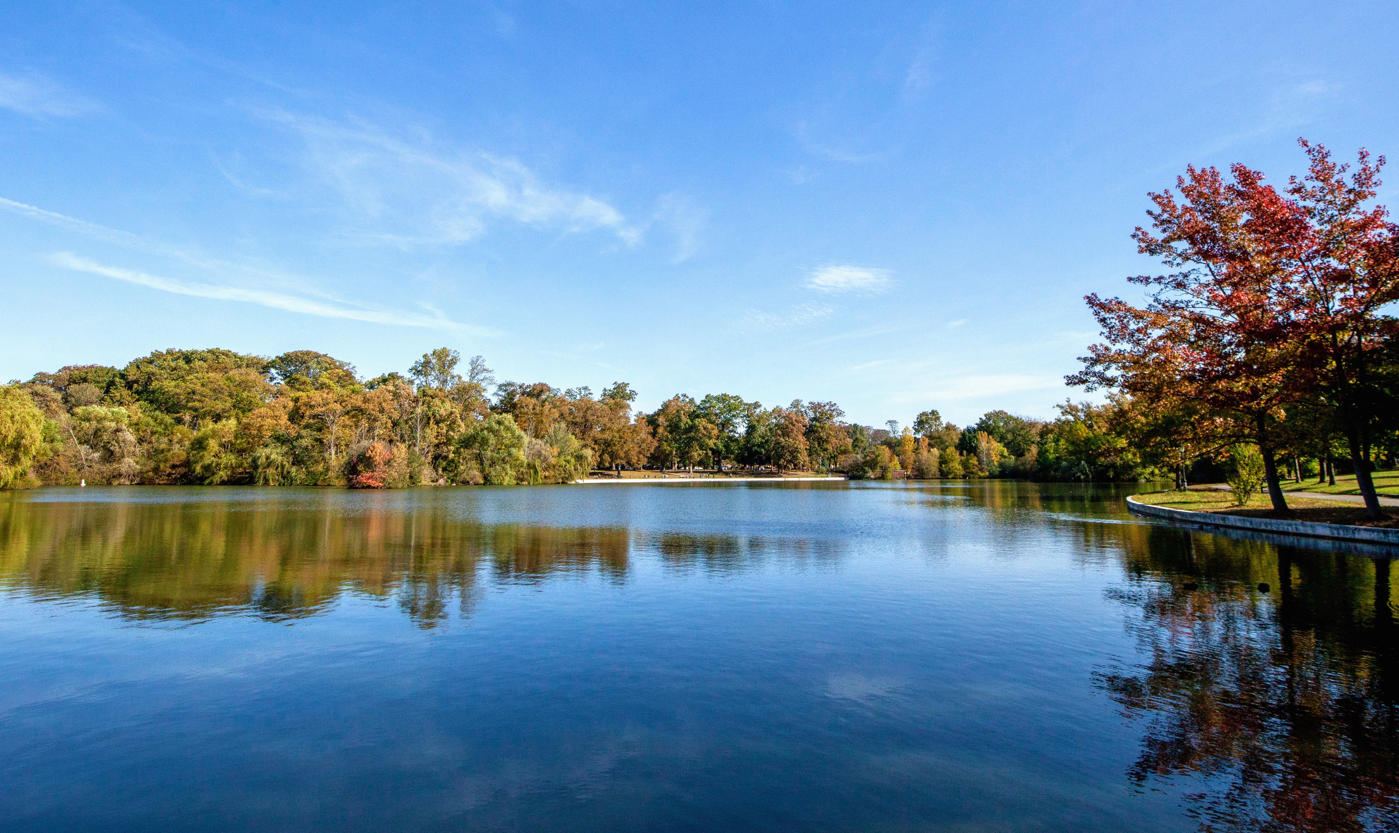 View of a lake flanked by fall colors on the trees