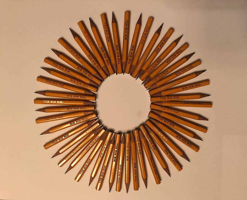 Tiny yellow golf pencils, each marked with the name Hob Nob Hill, are arranged in alternate positions to form a circular wreath