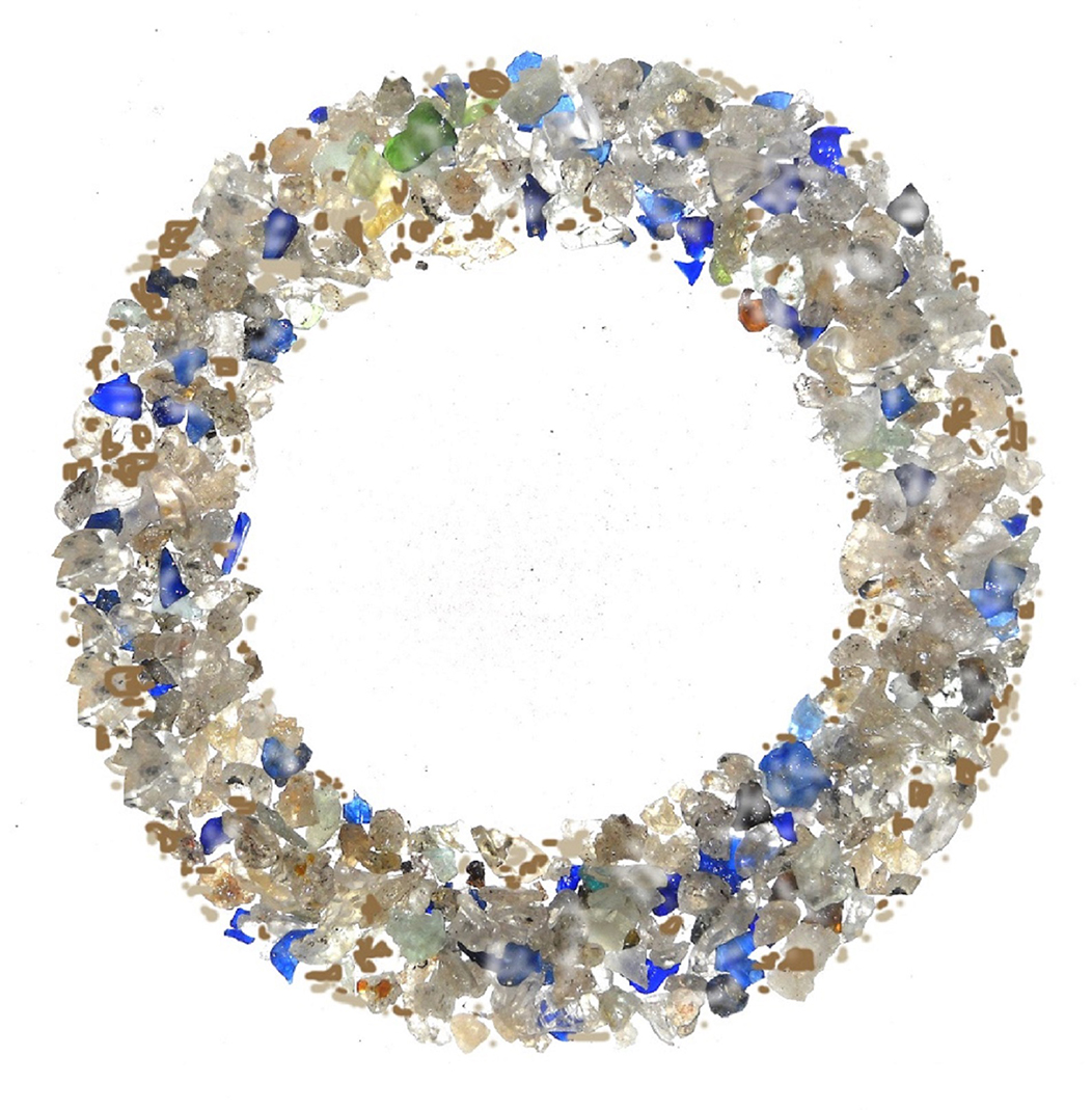 Glass in blue, white, silver, green, and tan colors are arranged to form a wreath