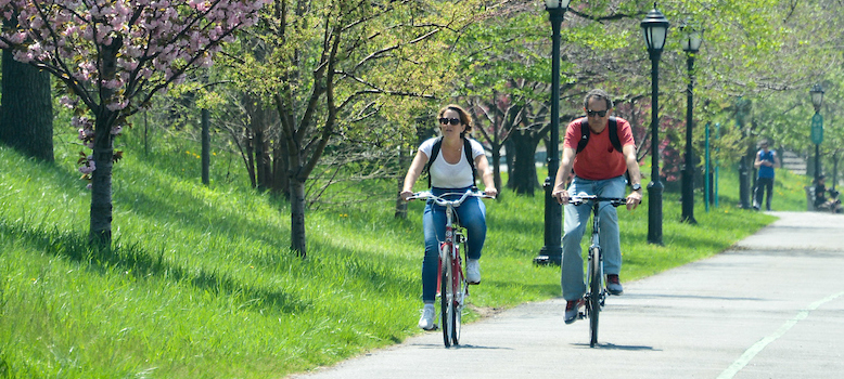 park guests cycle through the greenway while admiring the spring blooms