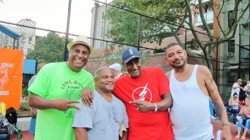 Members of the community pose for a photo in the park