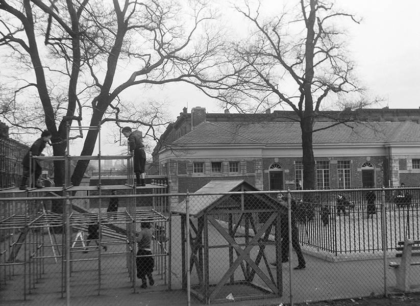 black and white archival photo of kids playing in the playground