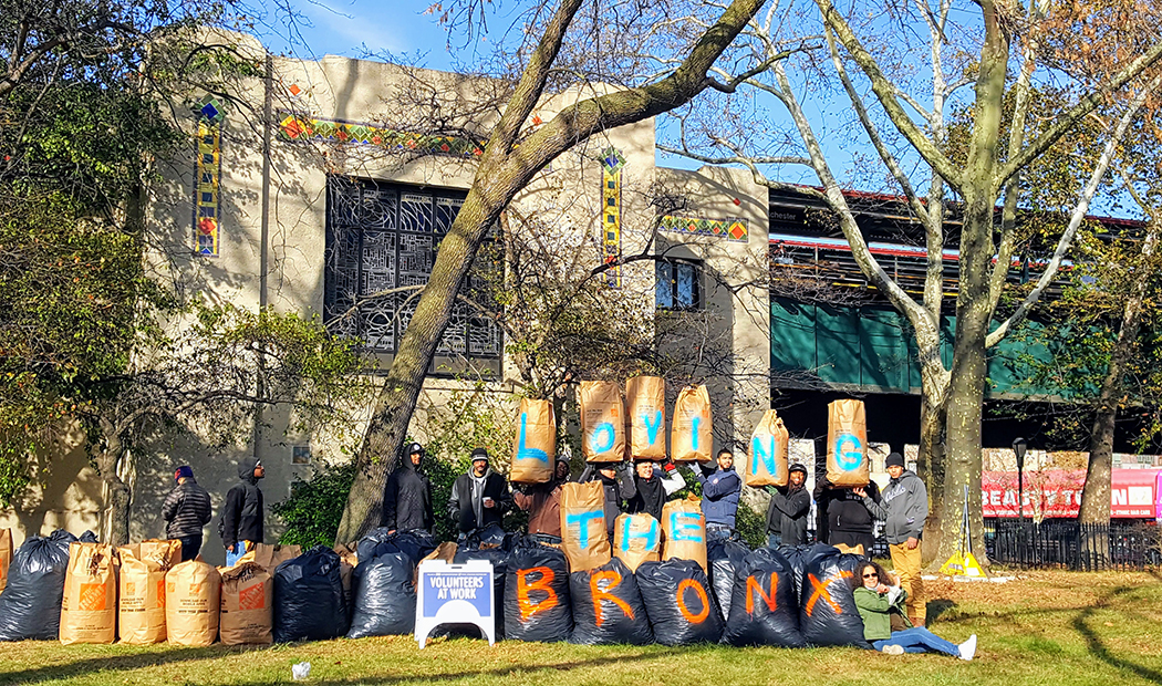 A display of bags of leaves that were raked up, the letters spelled out on the bags read Loving The Bronx