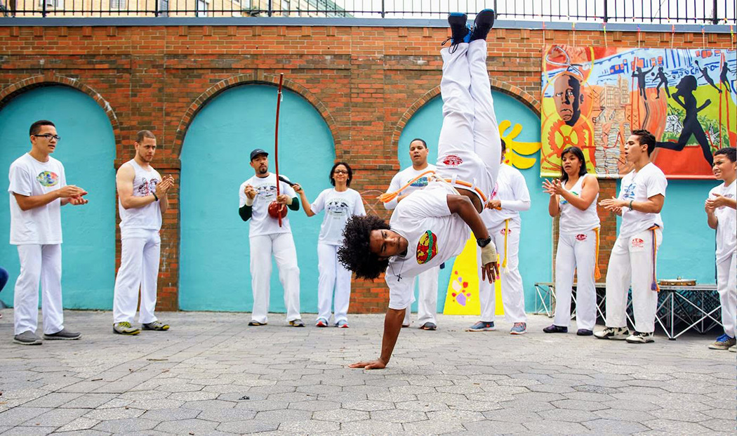 Performers gather around a dancer putting on a show