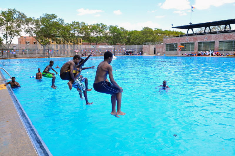 Kids hop into the outdoor pool