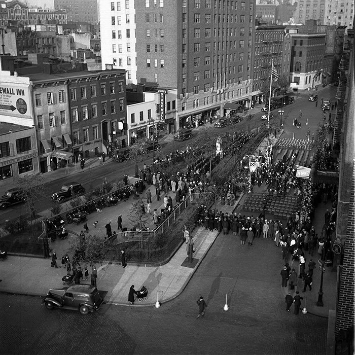 black and white archival image of community members gathering at the unveiling