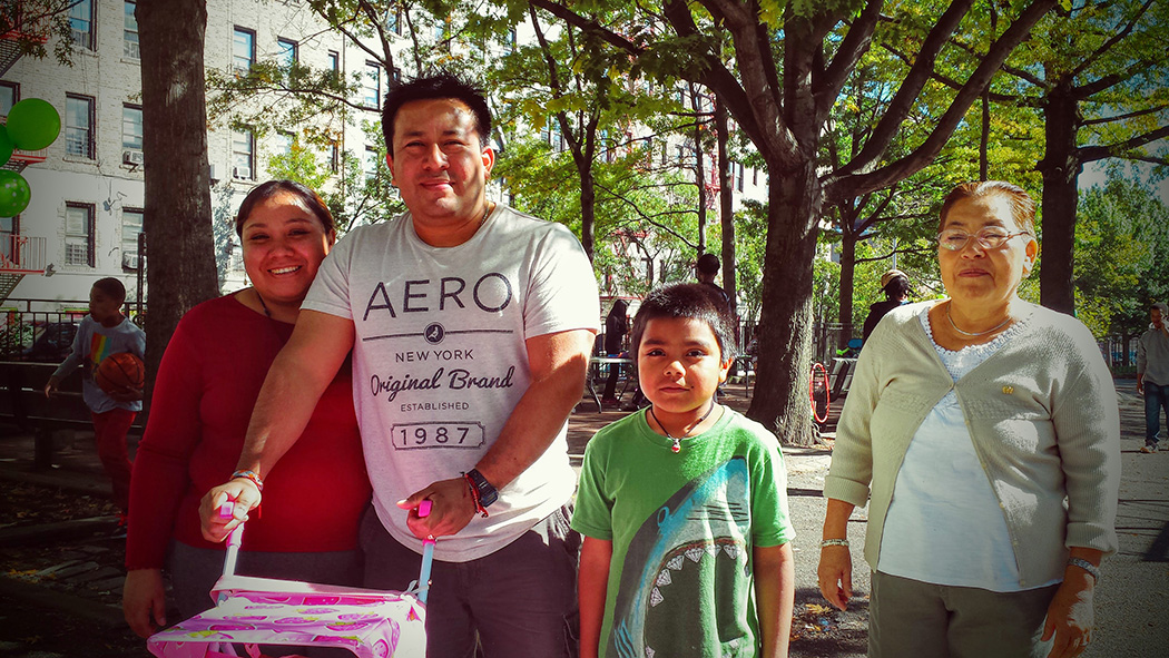 A family poses for a photo in the park