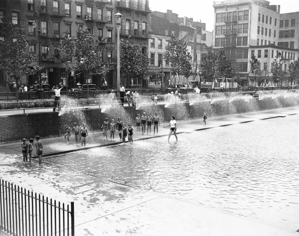 black and white archival image of kids splashing about in the water